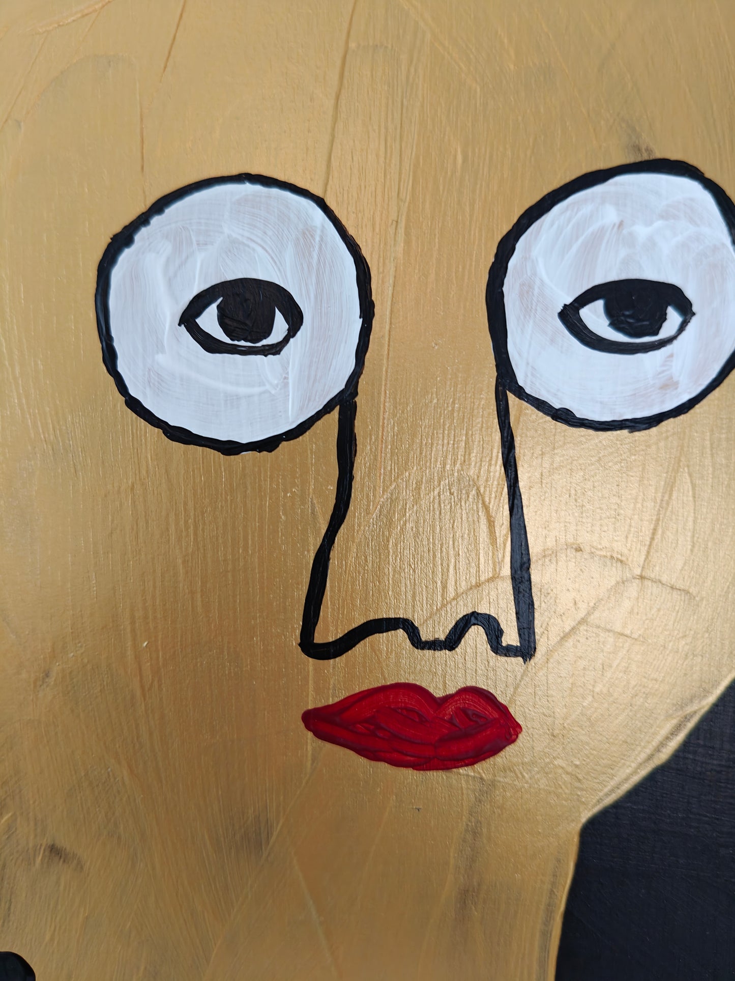 Close up of a Pop art portrait of a character in gold with red lips and large white eyes. The background of the painting is black.