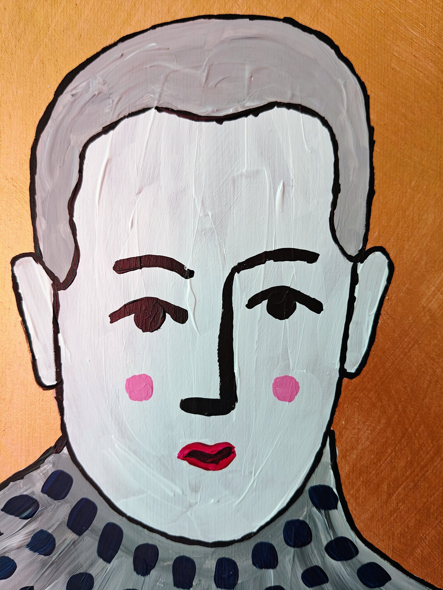 Close-up of A whimsical plywood painting featuring a stylised portrait of a figure with short grey hair, a soft expression, and rosy cheeks. The figure wears a cosy turtleneck sweater with dark polka dots. The metallic copper background contrasts beautifully with the natural wood of the plywood base. Part of the Life in Colour collection.