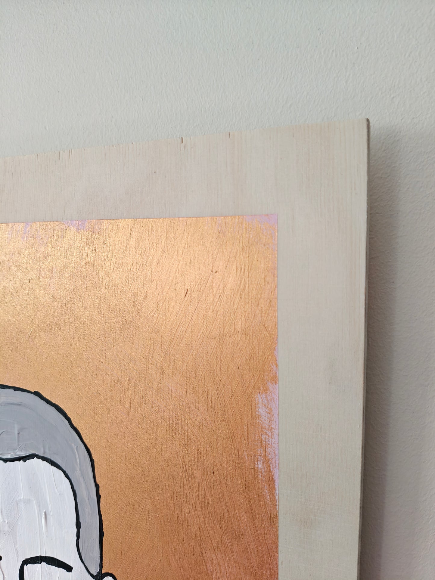 Close-up of a corner of a painting depicting a figure with short grey hair, a soft expression, and rosy cheeks. The metallic copper background contrasts beautifully with the natural wood of the plywood base. Part of the Life in Colour collection.