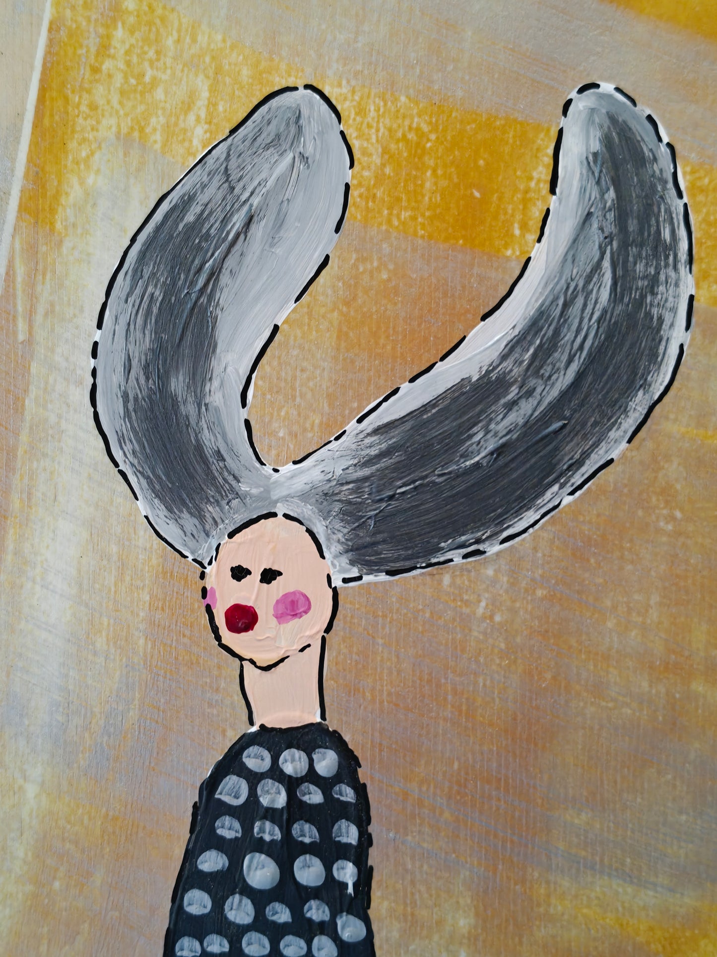 Close up of a Pop art painting of a woman with large flyaway hair and a black dress with silver spots on. The background of the painting is silver and yellow.