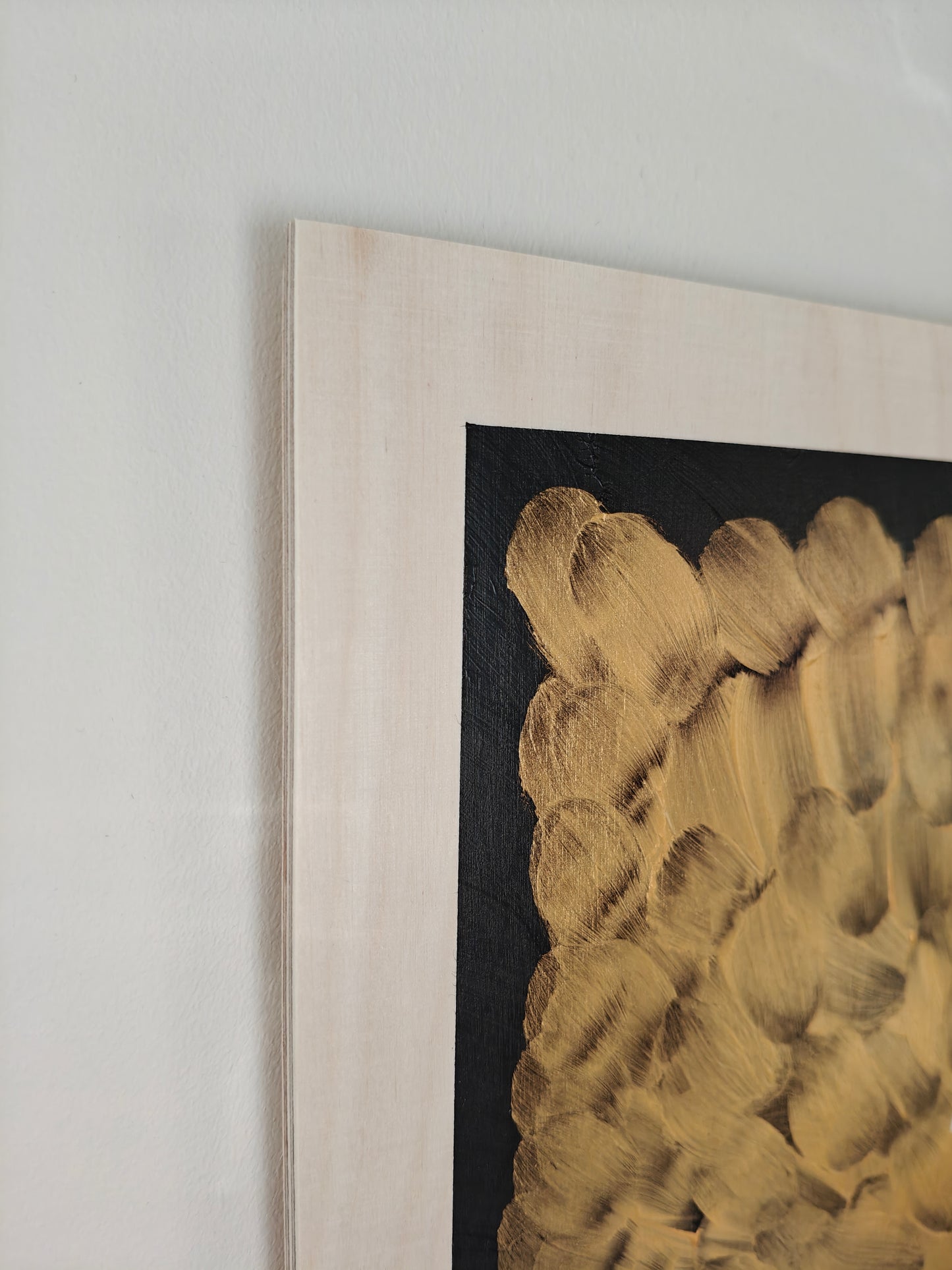 Close up of an Acrylic painting of a woman dressed in black and wearing sunglasses, pictured against a background of gold and black.