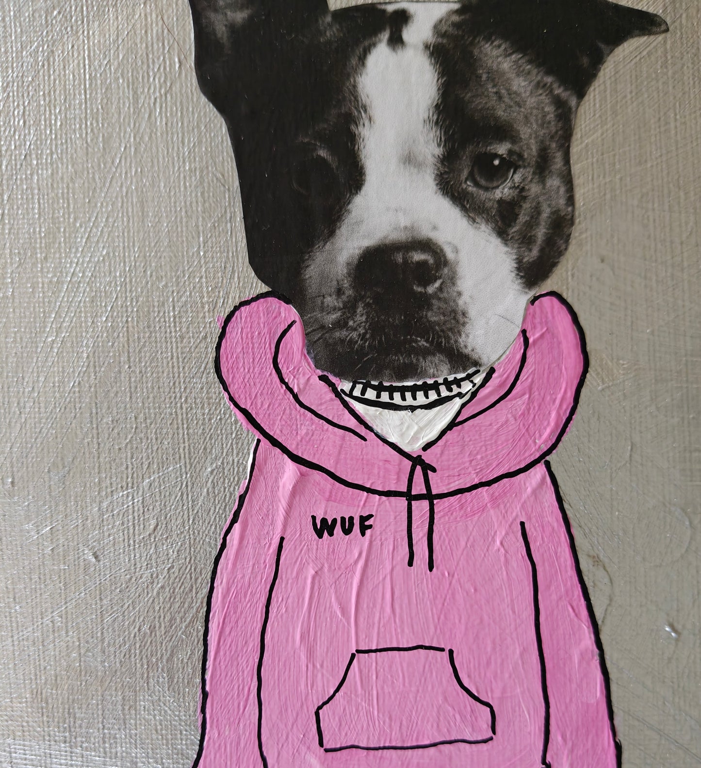 Close up of a Playful mixed media painting of a dog dressed in a hoodie with the word wuf written on the chest.