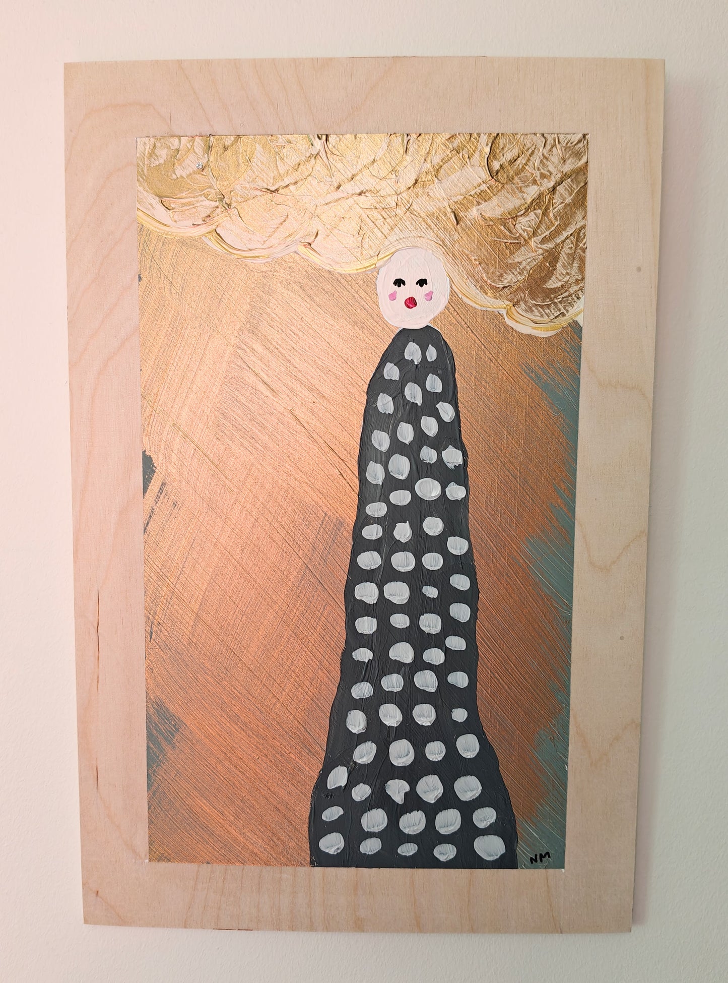 A whimsical painting of a figure with a dotted black dress, a round white head, and large golden cloud-like hair, standing against a gold metallic background with textured cloud-like accents. Painted on light wood.