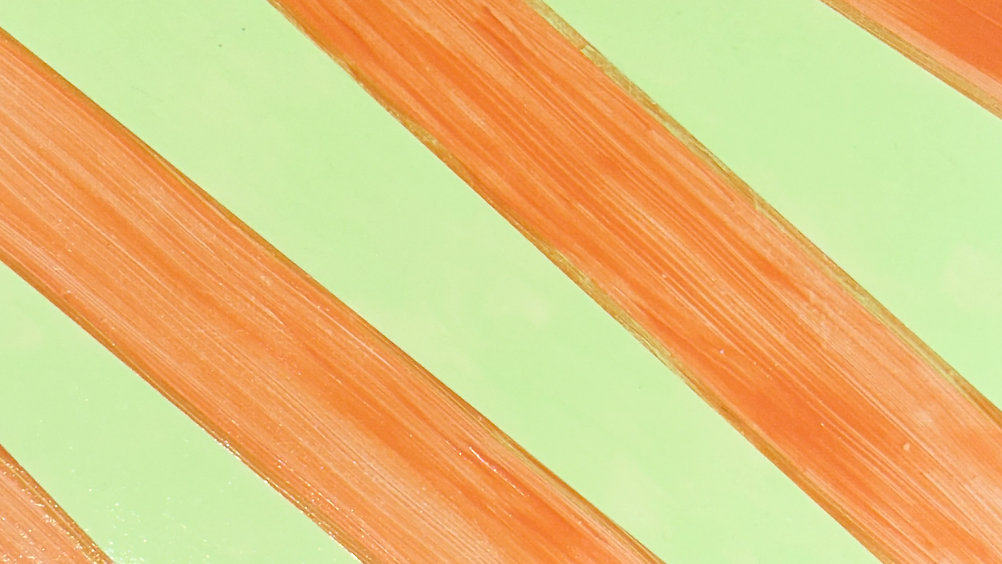 Plywood side table with hand-painted unique design in orange and green. Top view